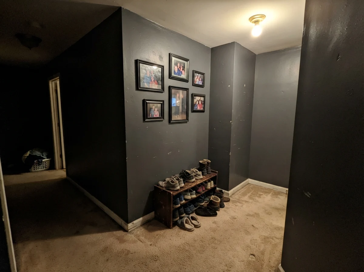 Windowless hallway corner showing Cyberspace reading flat, muddy and putty-like under a dim ceiling bulb